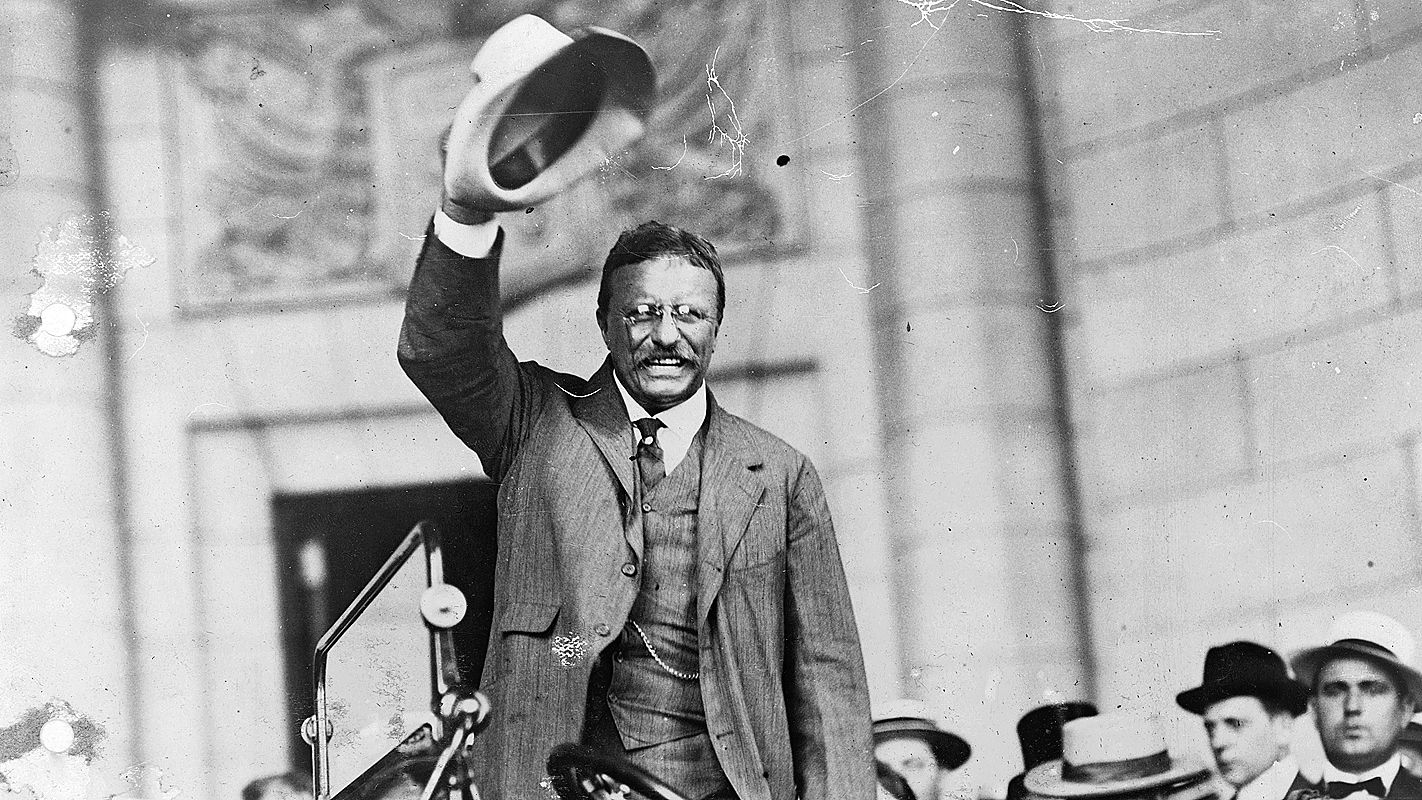 Theodore Roosevelt waves to the crowd.