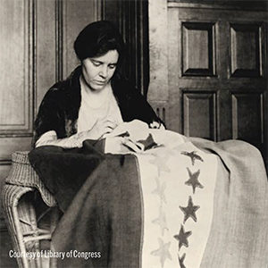 Suffragist and women’s rights activist Alice Paul sews stars on a flag marking state ratifications, Washington, DC, 1920