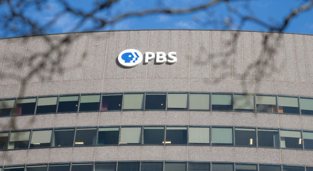 ARLINGTON, VA - FEBRUARY 18: A sign for the Public Broadcasting Service (PBS) is seen on its building headquarters on February 18, 2025 in Arlington, Virginia. The federal government's partial funding of the Public Broadcasting Service is now being examined by Elon Musk's U.S. Department of Government Efficiency (DOGE). Rep. Marjorie Taylor Greene (R-GA) has also called upon the head of PBS to testify in front of Congress next month on alleged news bias. (Photo by Kayla Bartkowski/Getty Images)